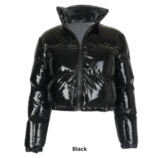 Black Puffer Jacket (limited edition) - Glossy Gang Close - up of shimmering glitter gloss applied to lips, showcasing a sparkly, reflective finish."