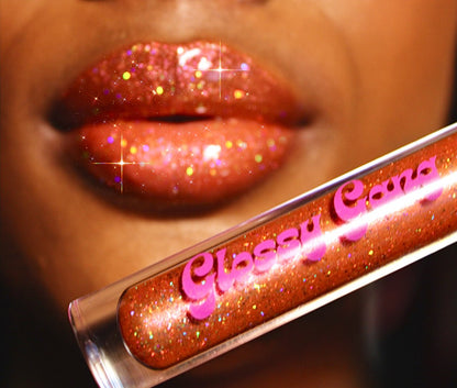 Carmel Drizzle #11 - Glossy Gang Lip GlossClose - up of shimmering glitter gloss applied to lips, showcasing a sparkly, reflective finish."