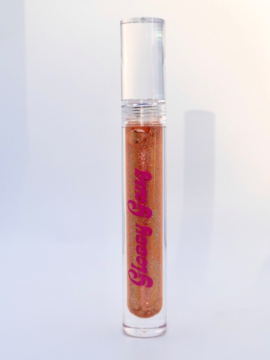 Carmel Drizzle #11 - Glossy Gang Lip GlossClose - up of shimmering glitter gloss applied to lips, showcasing a sparkly, reflective finish."