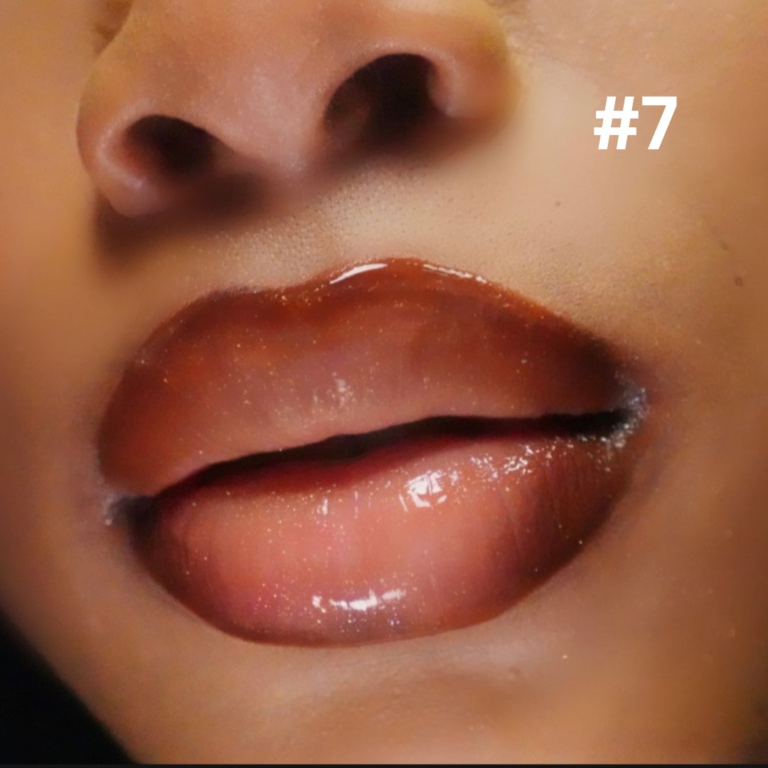 Coco Nior (#7) - Glossy Gang Close - up of shimmering glitter gloss applied to lips, showcasing a sparkly, reflective finish."