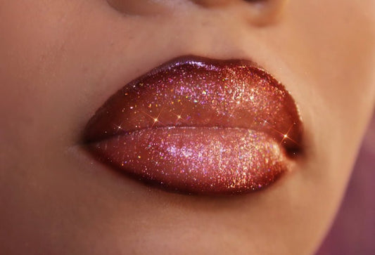 Honey Twist #9 - Glossy Gang Lip GlossClose - up of shimmering glitter gloss applied to lips, showcasing a sparkly, reflective finish."