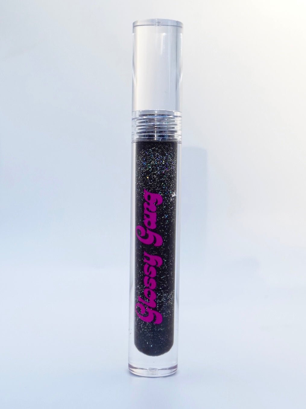 Raven #1 - Glossy Gang Lip GlossClose - up of shimmering glitter gloss applied to lips, showcasing a sparkly, reflective finish."