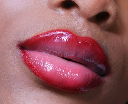 Rosey Red #3 - Glossy Gang Close - up of shimmering glitter gloss applied to lips, showcasing a sparkly, reflective finish."