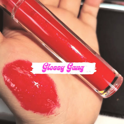 Ruby #8 - Glossy Gang Lip GlossClose - up of shimmering glitter gloss applied to lips, showcasing a sparkly, reflective finish."